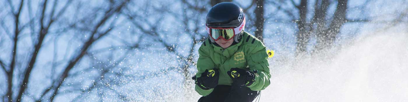 Young person downhill skiing